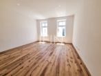 Wohnzimmer - Anleger aufgepasst! Stylische 1‑Zimmer-​Altbauwohnung im 3. Liftstock zu verkaufen – befristet vermietet!